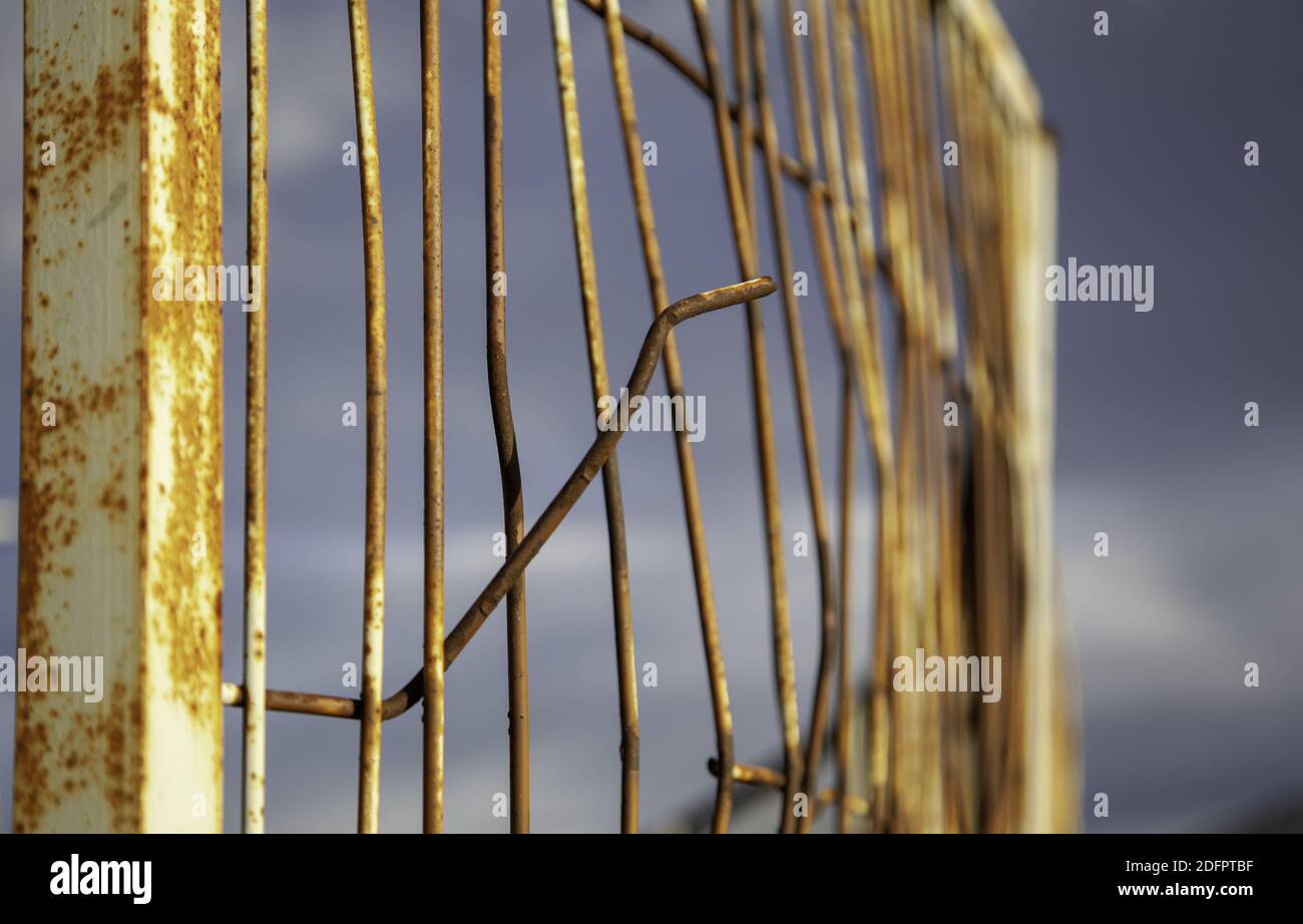 Deteriorated protective rusty fence, construction and architecture, industry Stock Photo