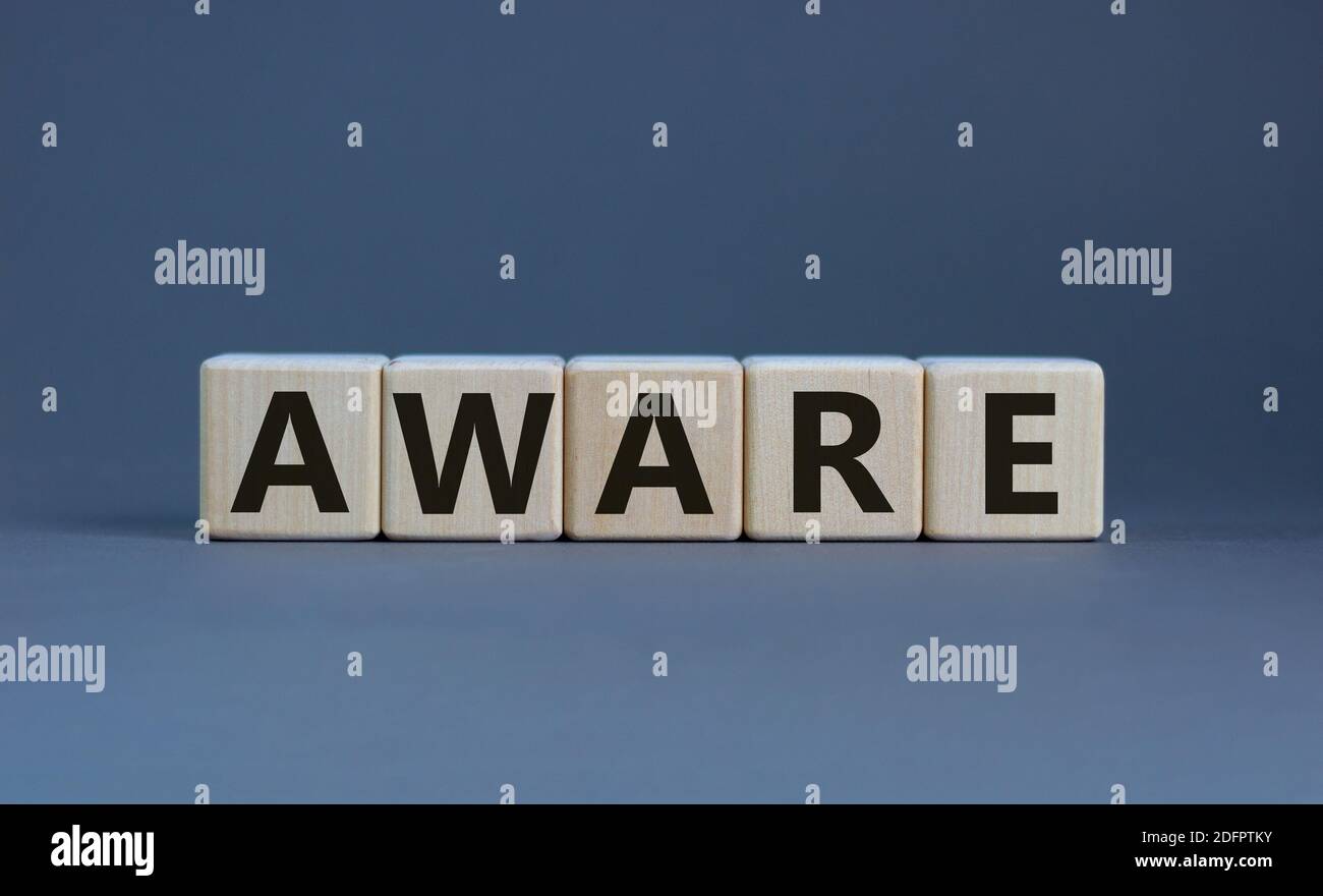 Aware symbol. Wooden cubes with the word 'aware'. Beautiful grey background. Business and aware concept. Copy space. Stock Photo