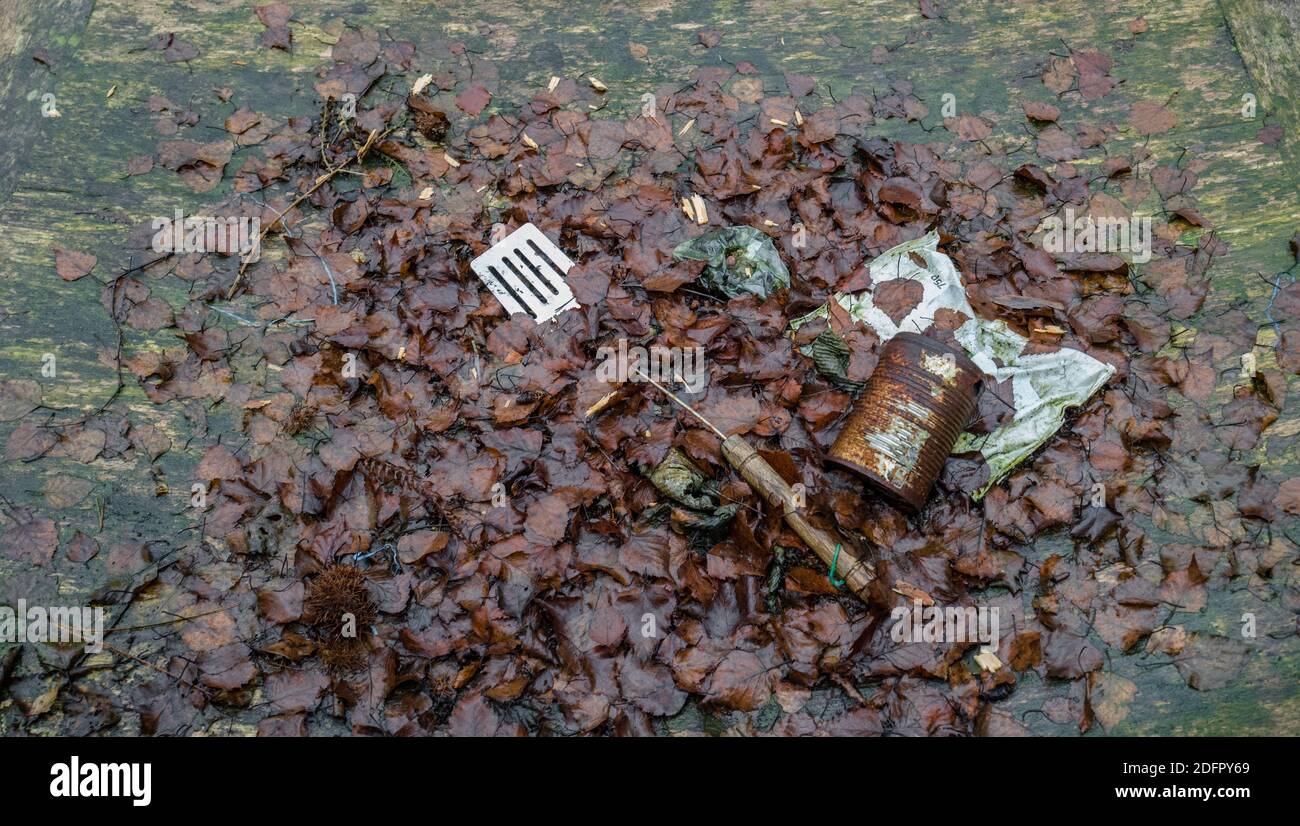 Rusty tin can and kitchen utensil left outside on a wooden table. Stock Photo
