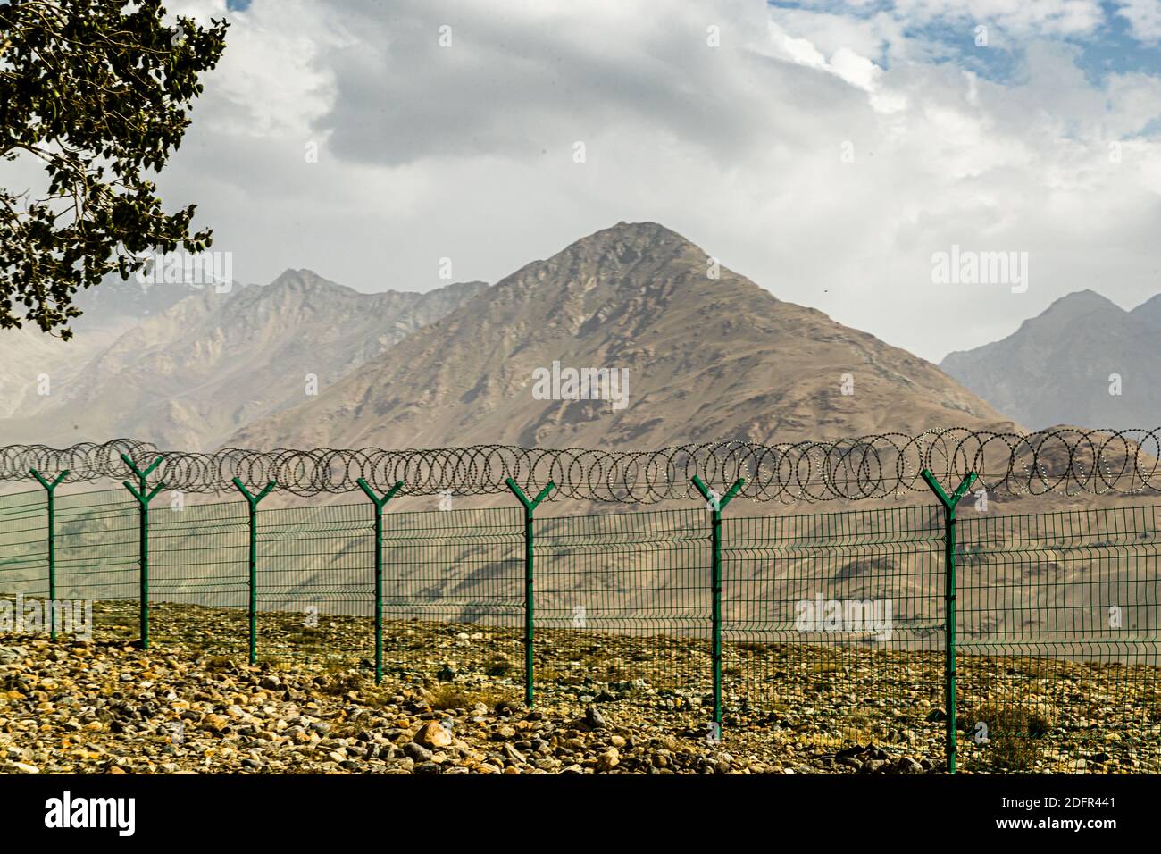 Border Fence at the Silk Road between Tajikistan and Afghanistan Stock Photo