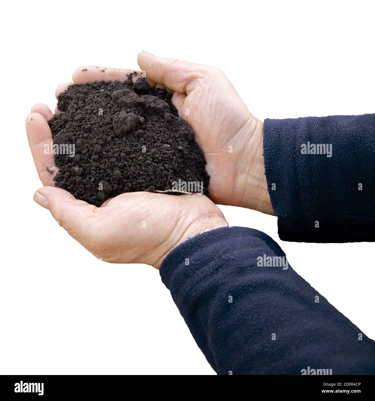 Farmer holding soil in hands close-up. View from above. Agriculture, gardening. Stock Photo