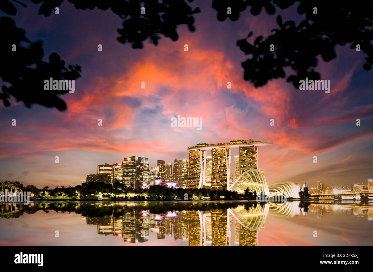 Stunning view of the Singapore's skyline during a beautiful and dramatic sunset.  Singapore is a sovereign island city-state in Southeast Asia. Stock Photo