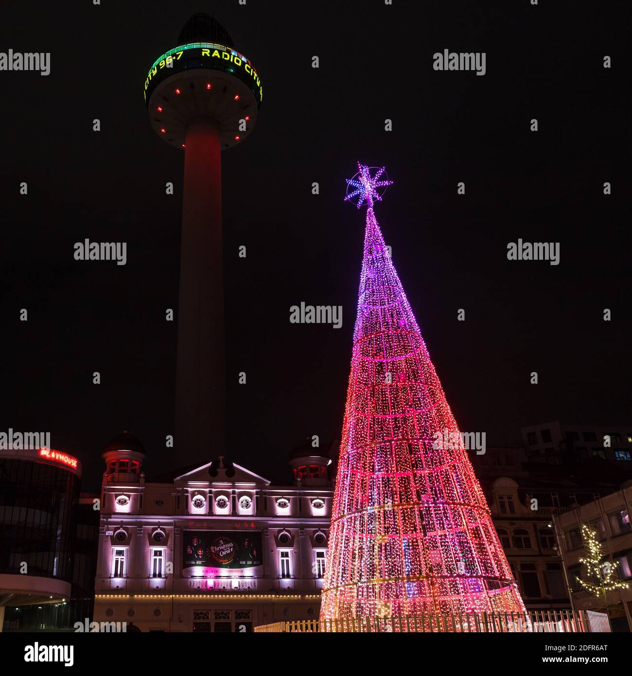 A large colourful Christmas tree captured in Williamson Square in Liverpool in front of the Playhouse theatre in December 2020. Stock Photo