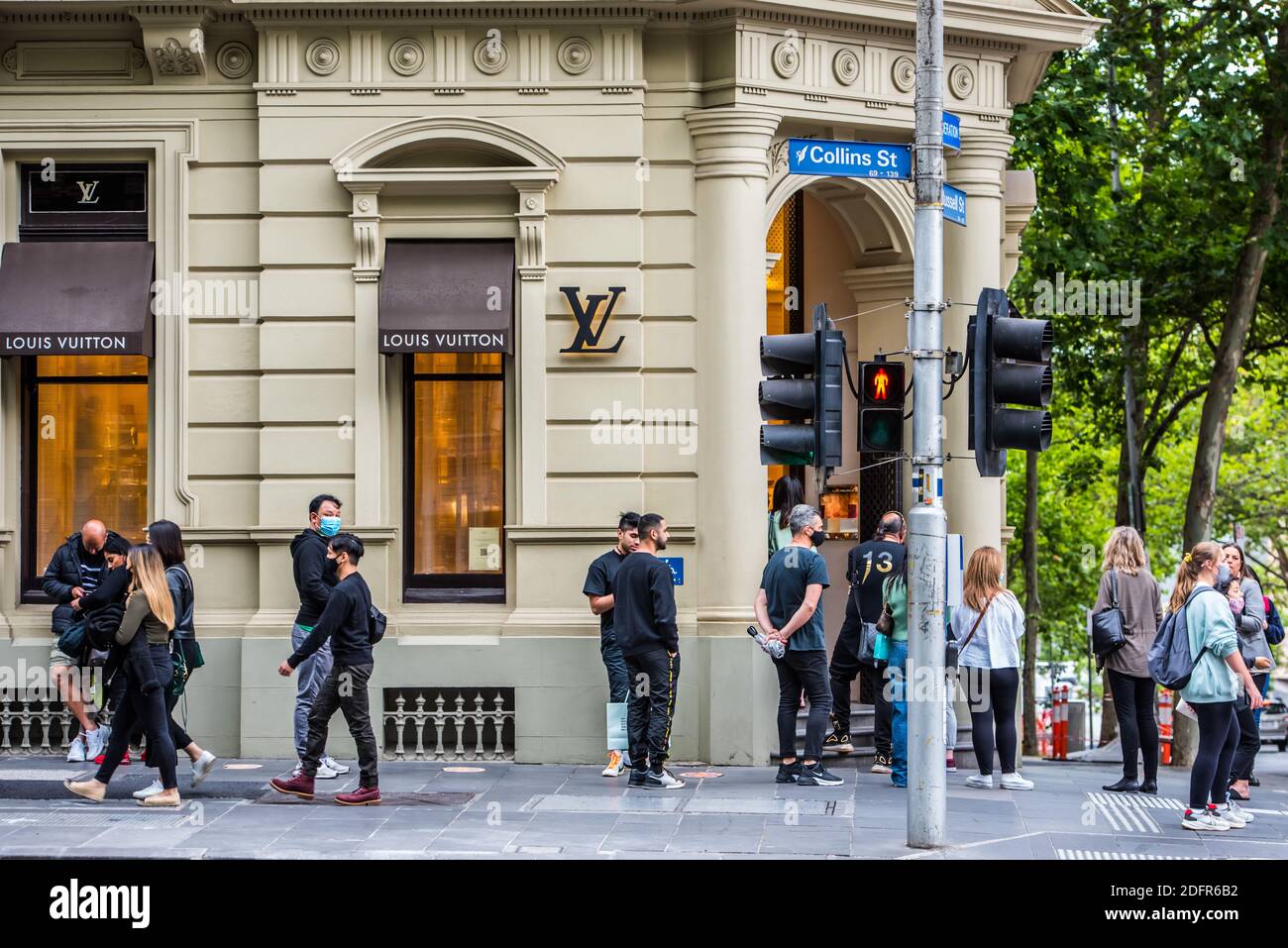 People seen lining up outside Louis Vuitton store in the rain on