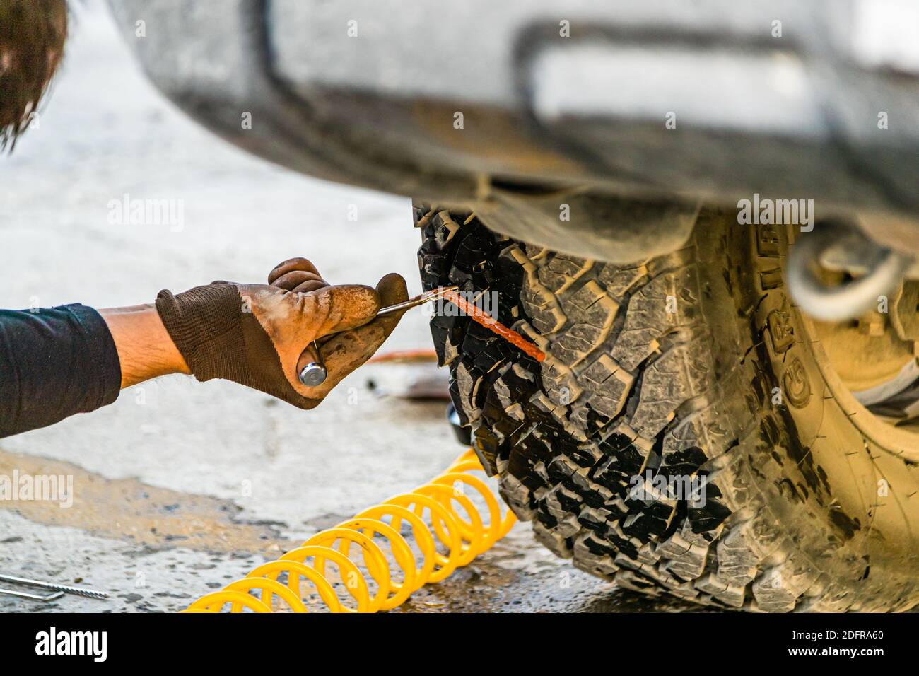Expedition style tire repair on the Silk Road in Murghab, Tajikistan Stock Photo
