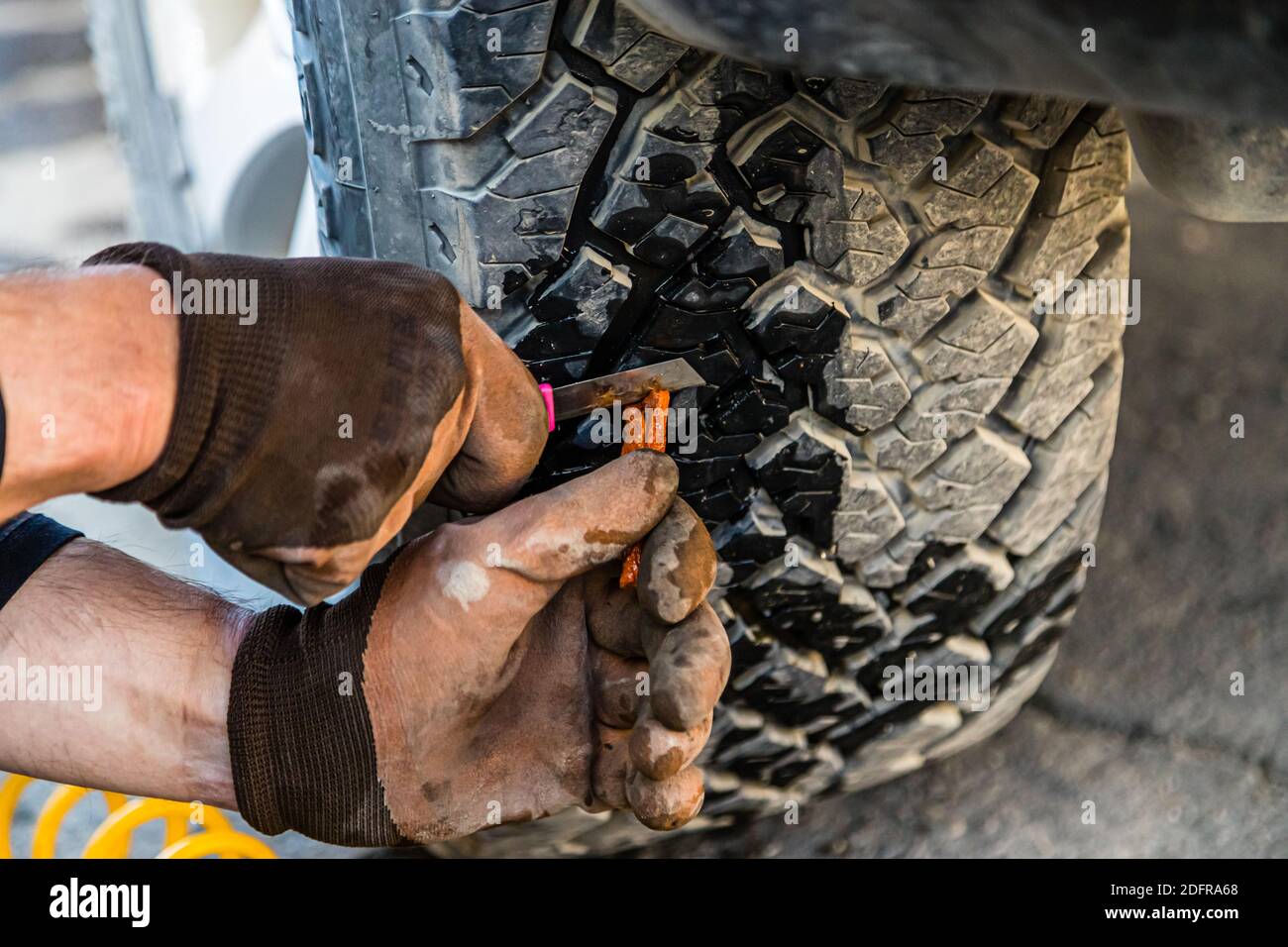 Expedition style tire repair on the Silk Road in Murghab, Tajikistan Stock Photo