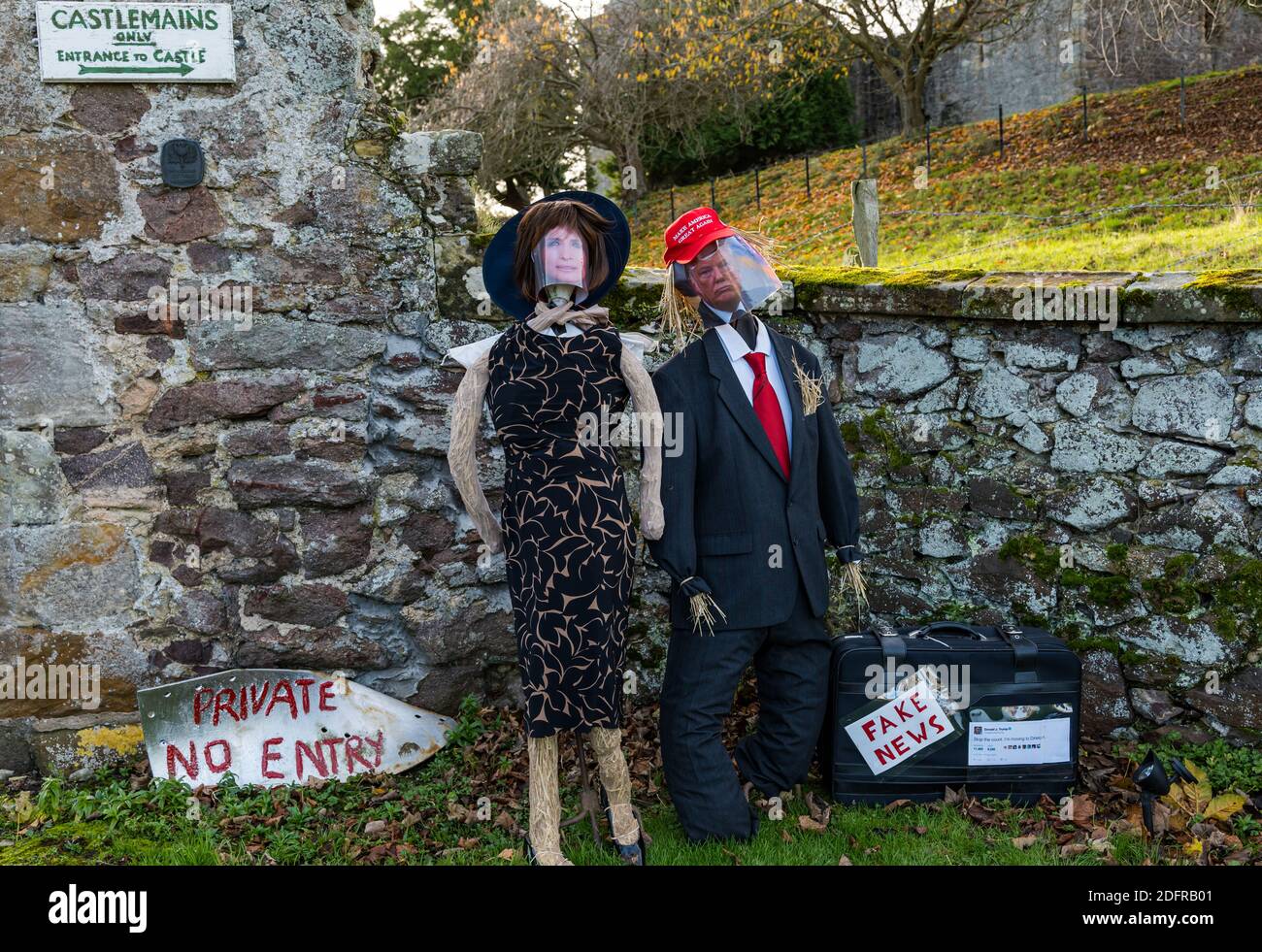 Quirky Donald and Melania Trump scarecrows with a fake news box, Dirleton, East Lothian, Scotland, UK Stock Photo