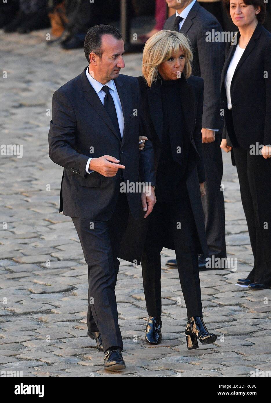 Brigitte Macron and Chief of Protocol Jose Pietroboni during the national  tribute ceremony to honour French-Armenian singer Charles Aznavour, one of  Frances most famous stars, who died aged 94, in the courtyard