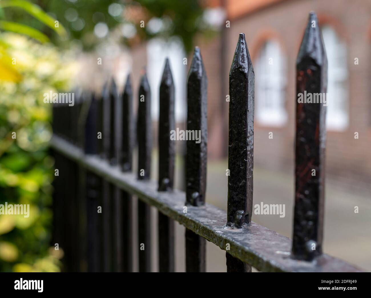 Close up of a black railing at a park with blurred background of a London street Stock Photo