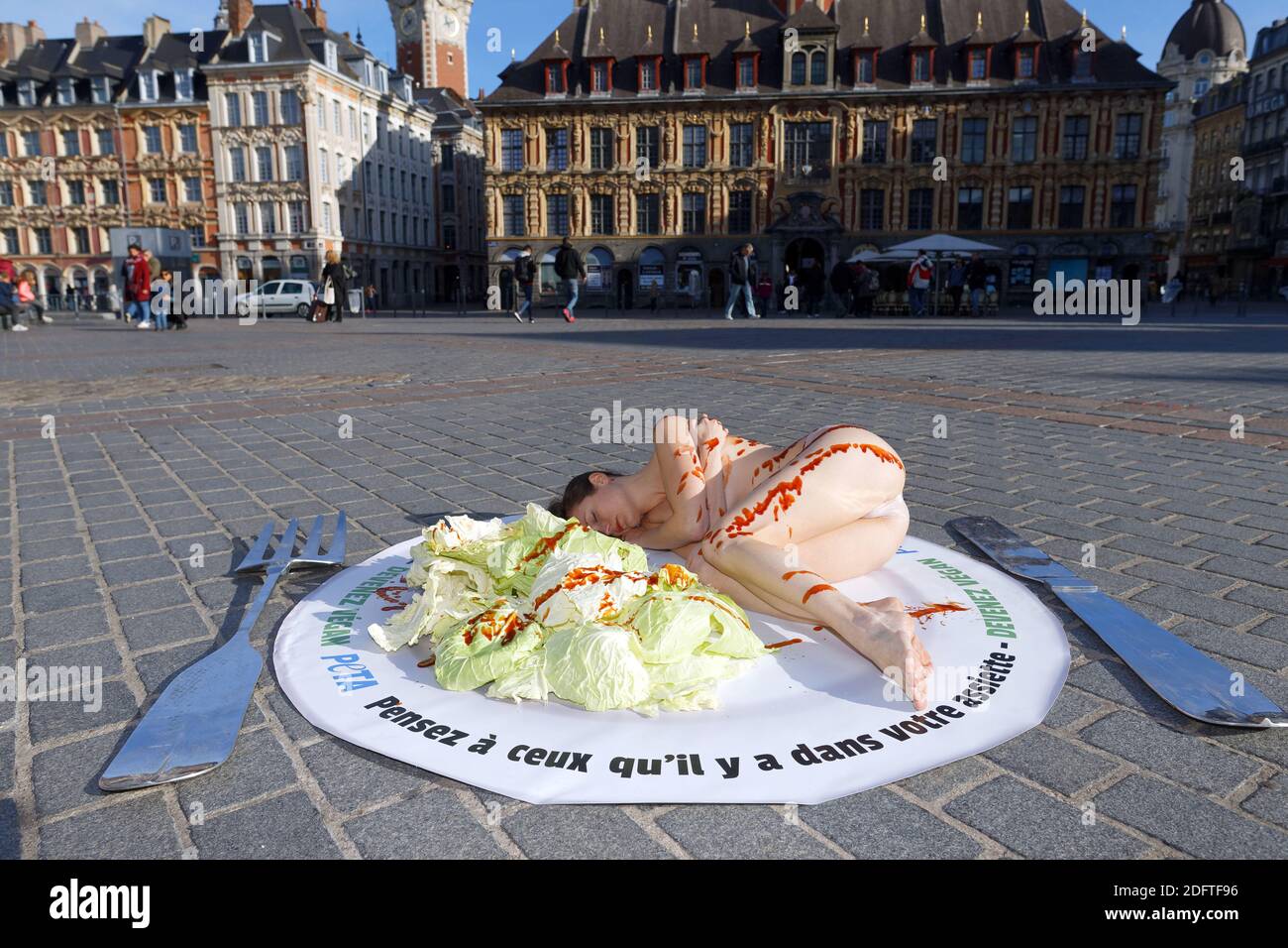 An activist with PETA (People for the Ethical Treatment of Animals) lies  covered with barbecue sauce during a protest against the consumption of  animal products in Lille, France, November 01st, 2018. Photo