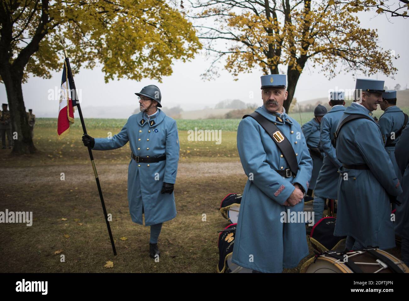 History enthusiasts, dressed with vintage army uniforms as Poilu (French  soldier in World War I), following a tribute ceremony at the War memorial  in Morhange, eastern France, on November 5, 2018, as
