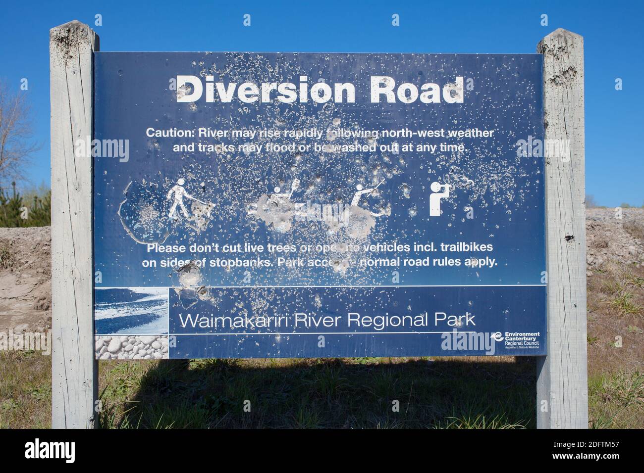 Iconic Kiwi Road-signs: this one has been peppered with shot-gun pellets and .22 bullets. North Canterbury, South Island New Zealand. Stock Photo