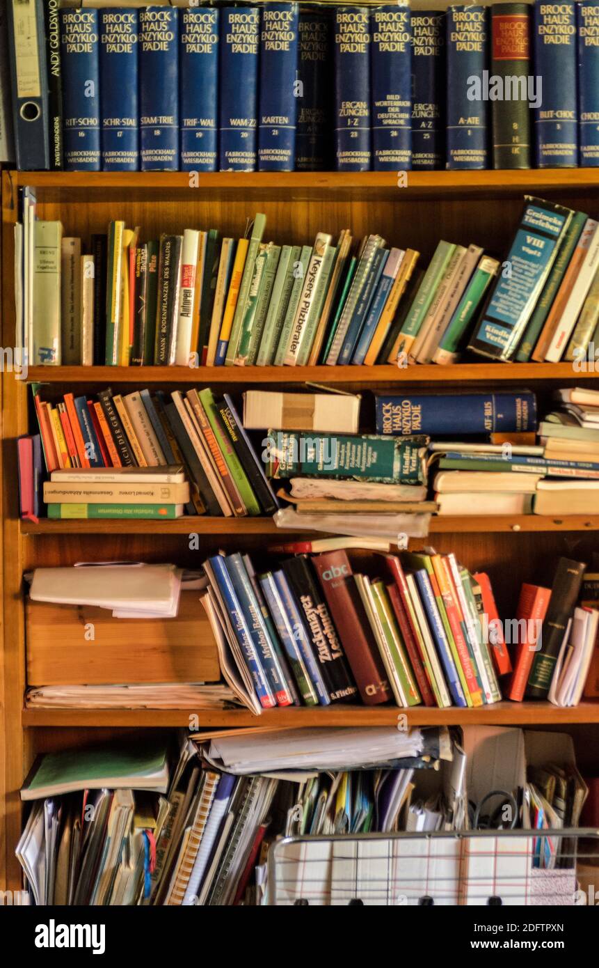 many books on a wooden shelf Stock Photo