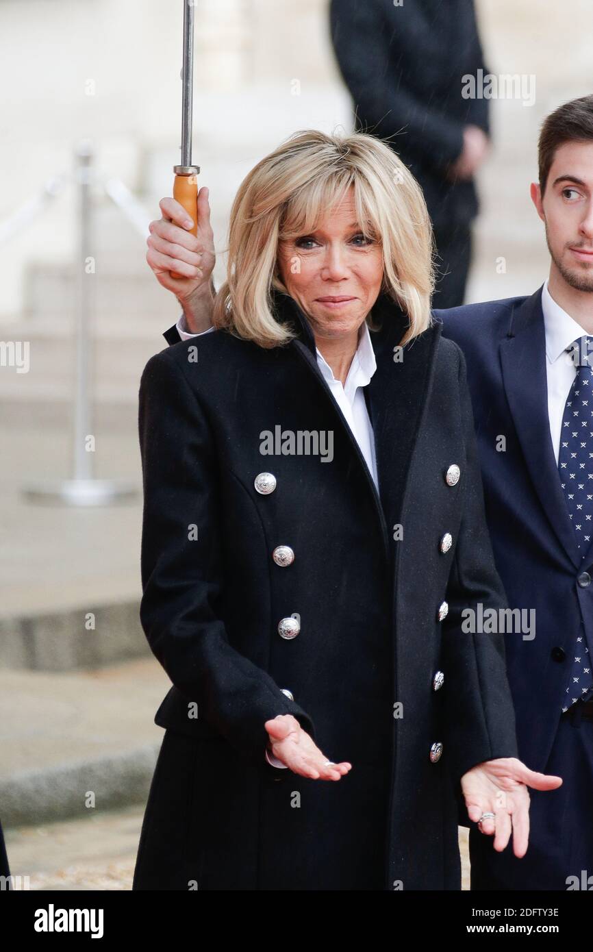 French President Emmanuel Macron and his wife Brigitte Macron welcome ...