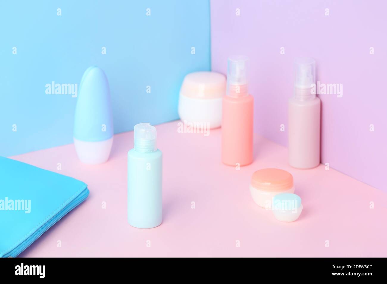 Travel cosmetics kit on color background Stock Photo - Alamy