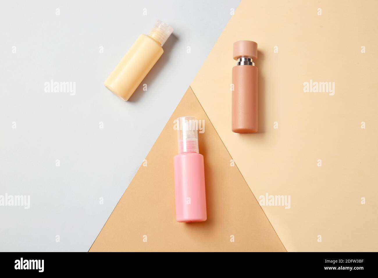 Travel cosmetics kit on color background Stock Photo - Alamy