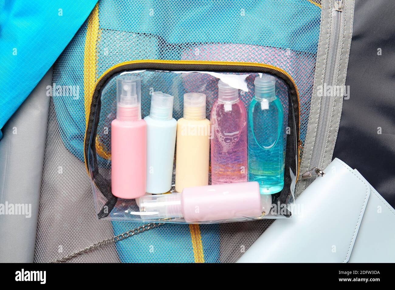 Travel kit bag on packed suitcase Stock Photo Alamy