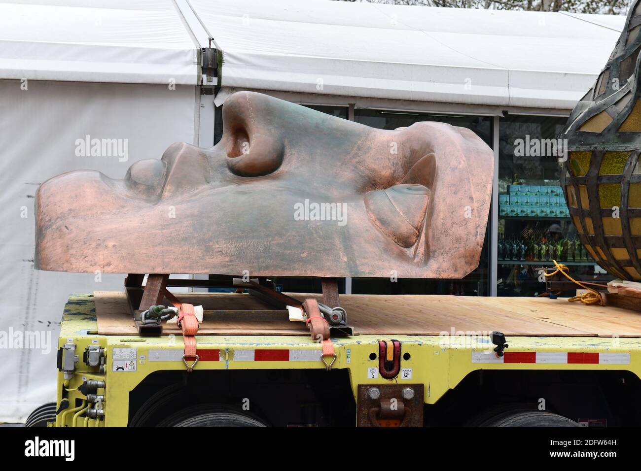 Workers transport the Statue of Liberty original torch along with a replica of the statue's face