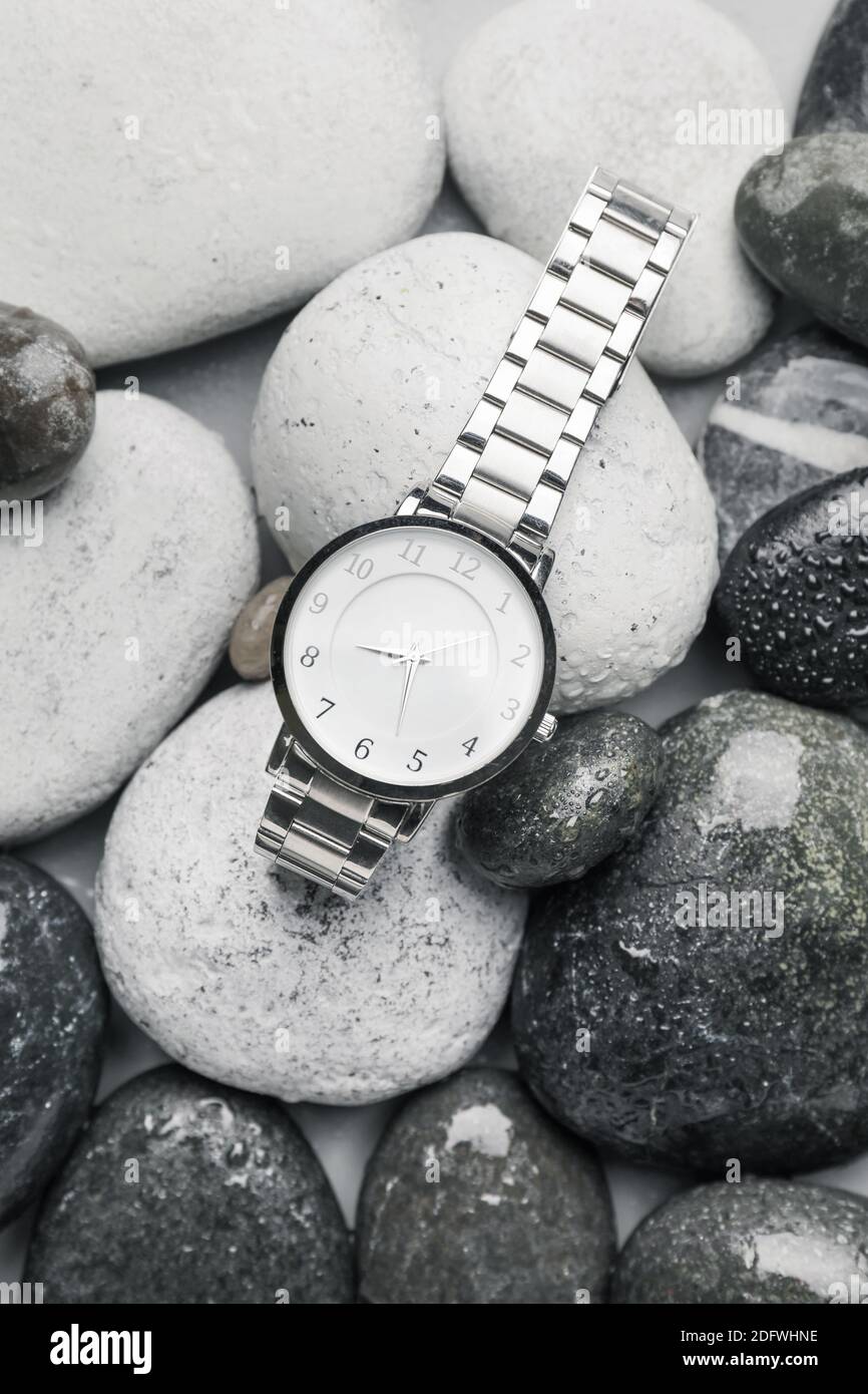 Wrist watch on wet pebbles Stock Photo - Alamy
