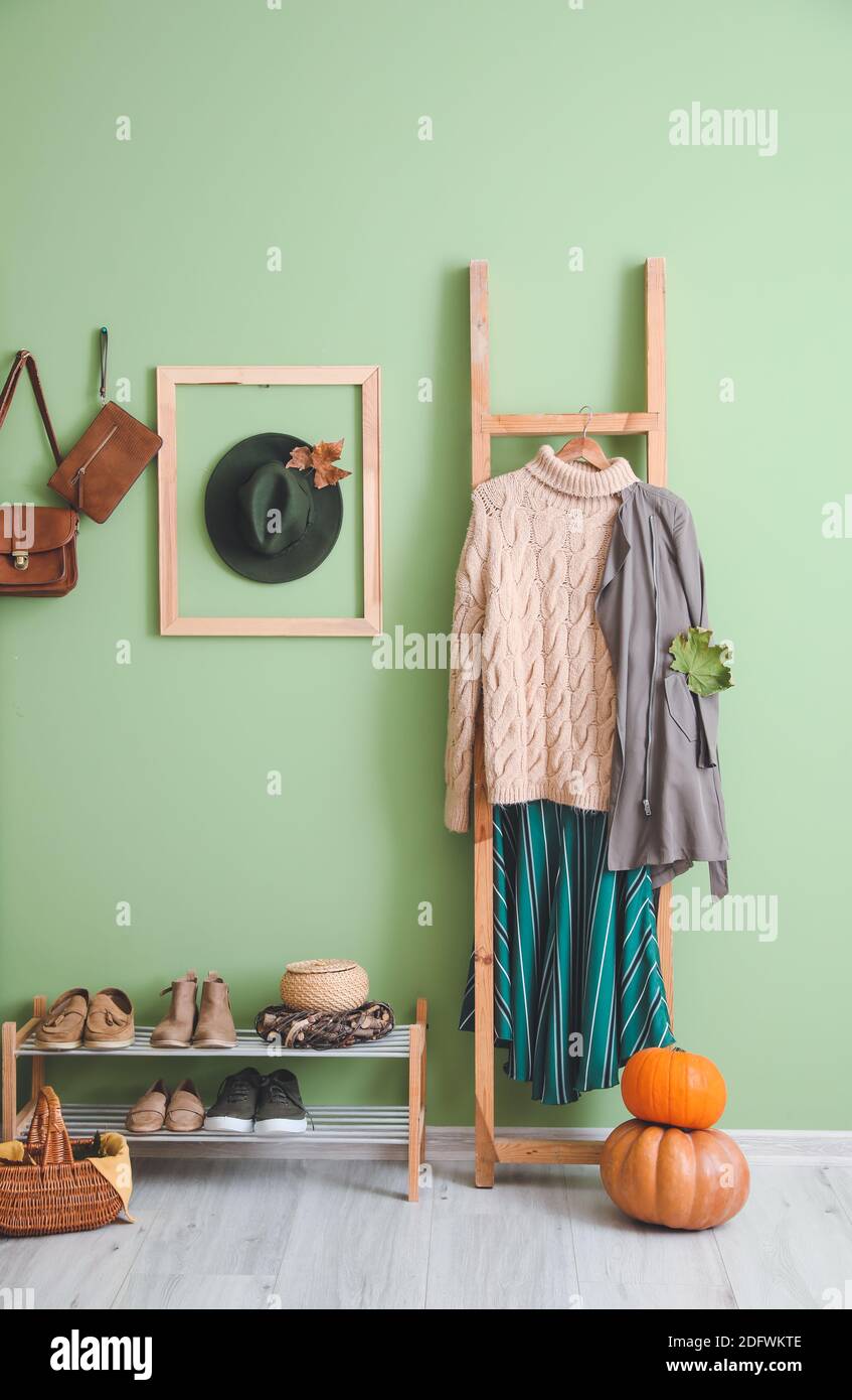 Rack with autumn clothes in interior of modern hallway Stock Photo - Alamy