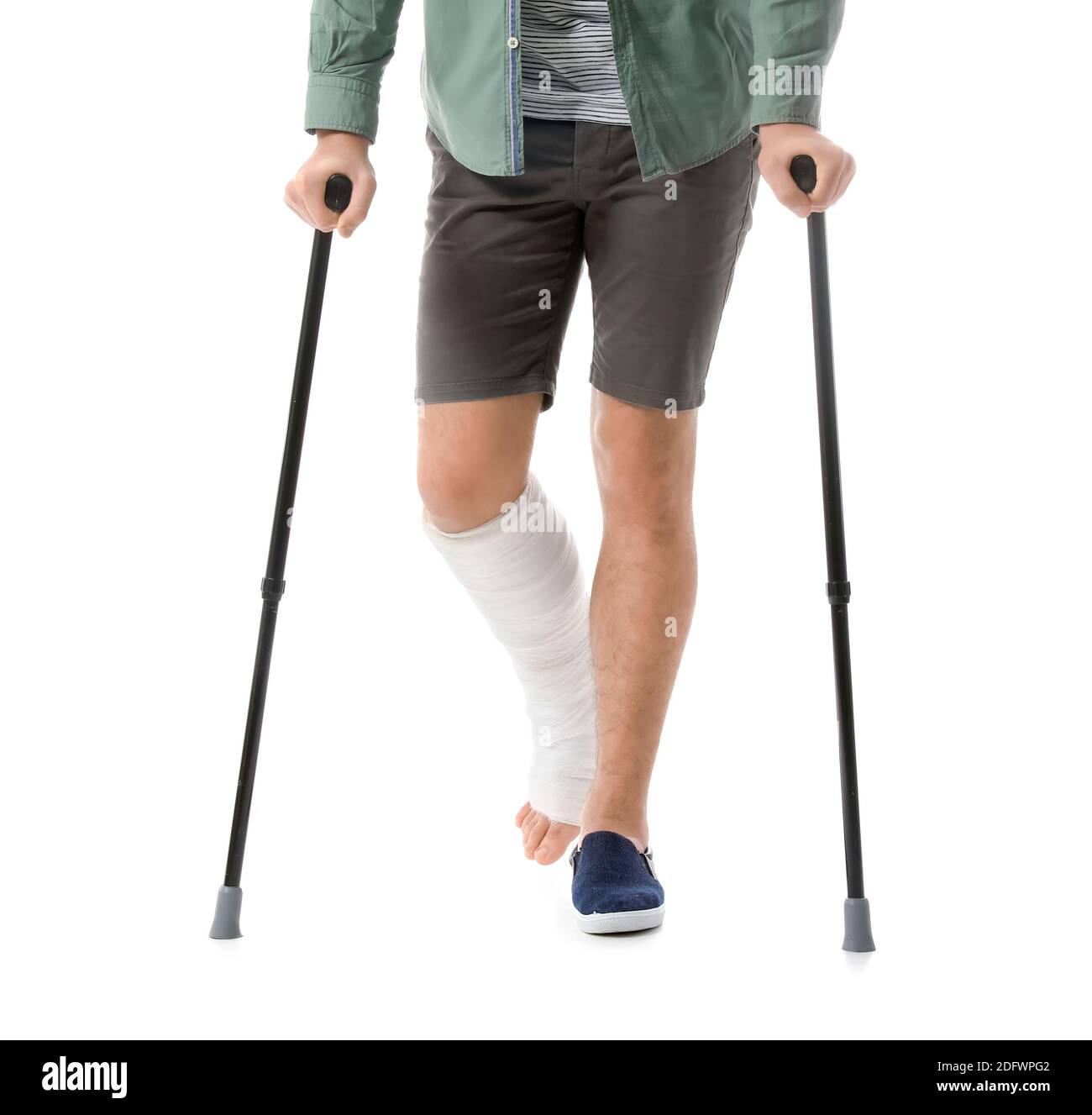 Young man with broken leg on white background Stock Photo - Alamy