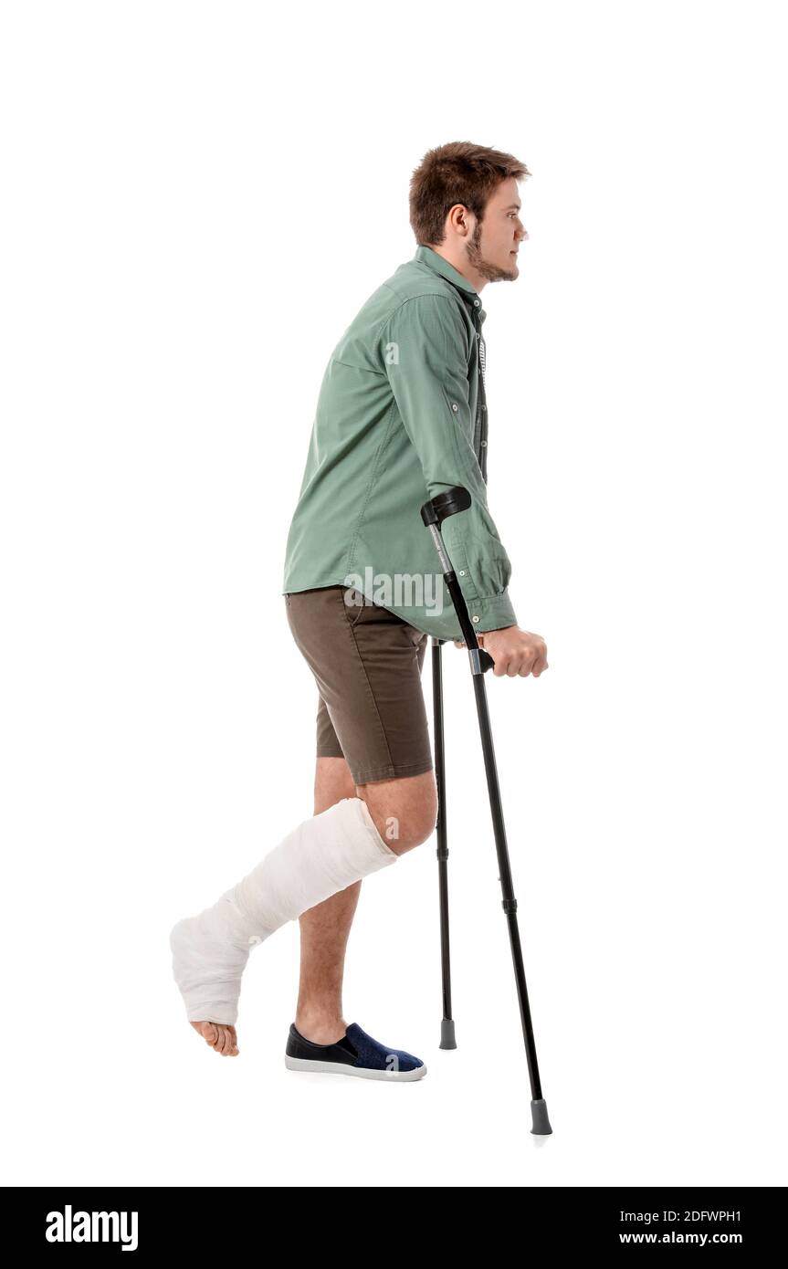 Young man with broken leg on white background Stock Photo Alamy