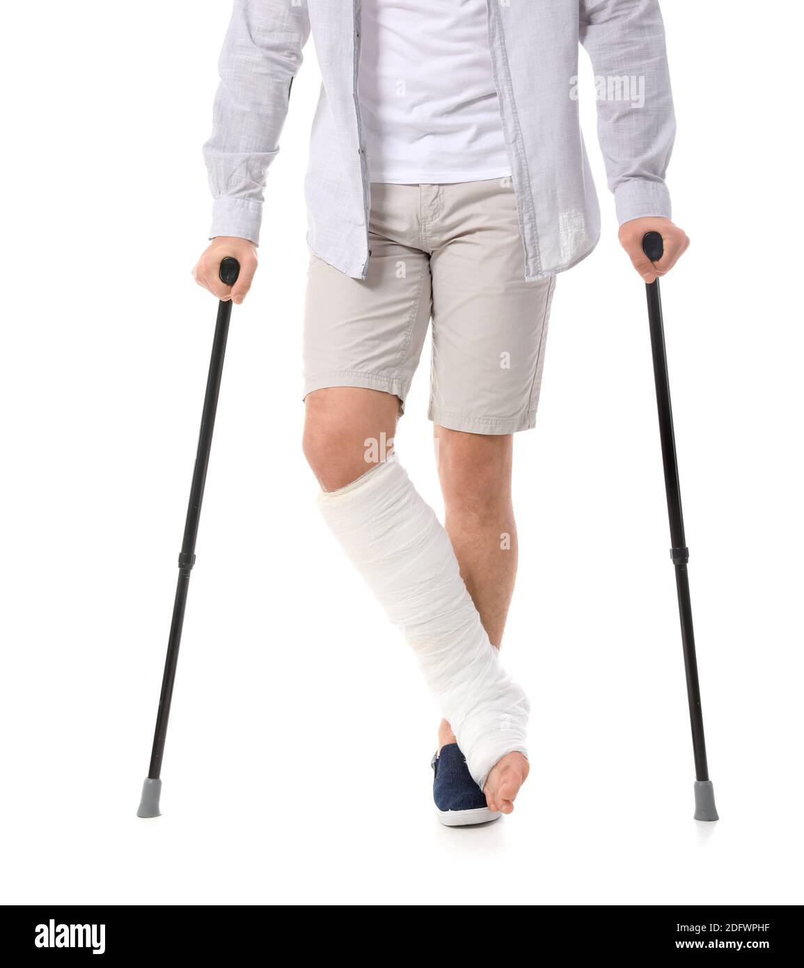 Young man with broken leg on white background Stock Photo - Alamy