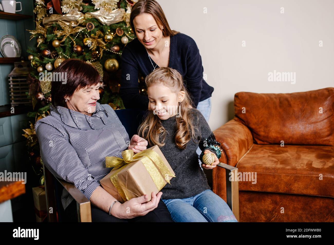 Excited Grandmother Receiving Christmas Gift From Granddaughter At Home  Stock Photo - Alamy