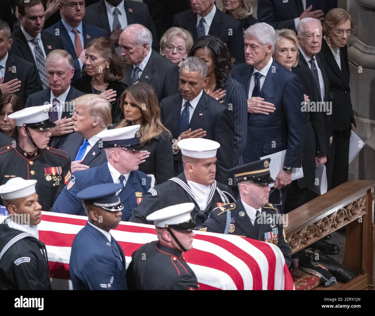 Dignitaries pay their respects as the casket containing the remains of the late former United States President George H.W. Bush at the National funeral service in his honor at the Washington National Cathedral in Washington, DC on Wednesday, December 5, 2018. Front row: United States President Donald J. Trump, first lady Melania Trump, former US President Barack Obama, former US President Bill Clinton, former US Secretary of State Hillary Rodham Clinton, former US President Jimmy Carter and former first lady Rosalynn Carter. Second row: former US Vice President Dan Quayle, Marilyn Quayle, form Stock Photo
