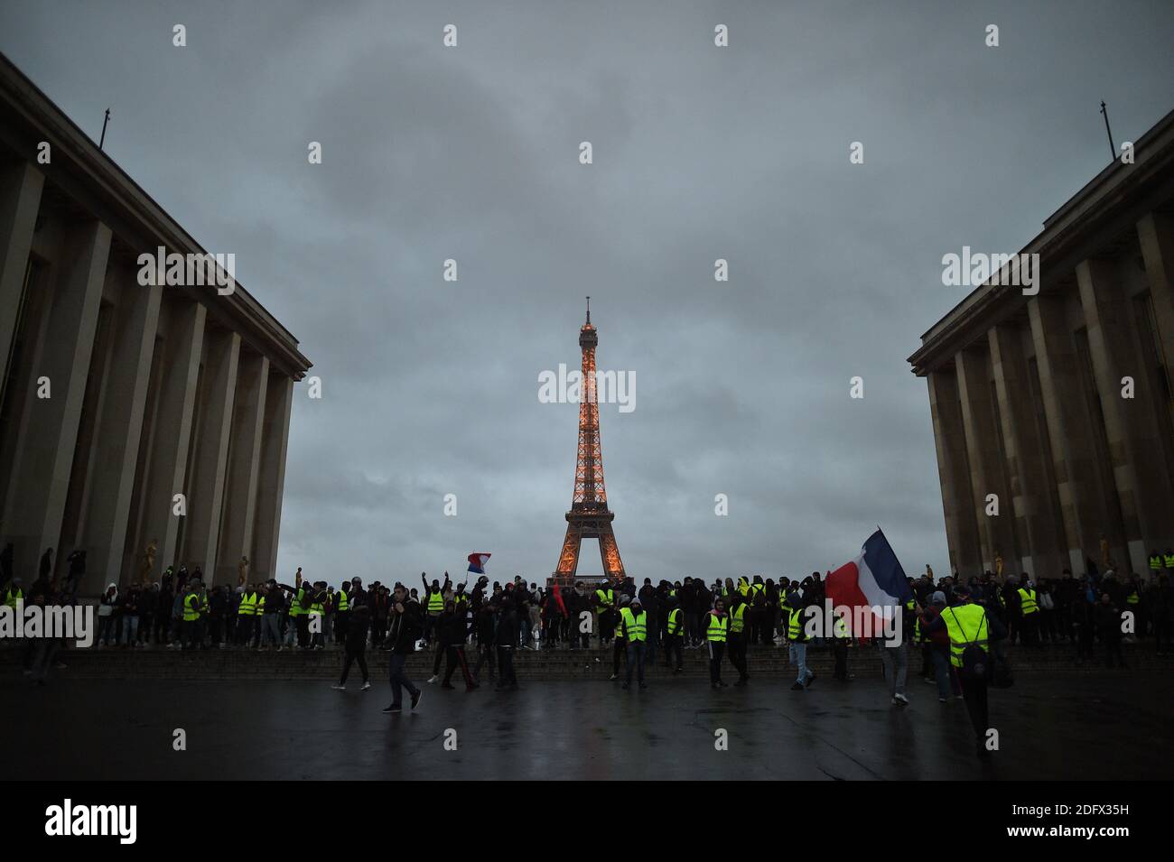Protestors stand on the Trocadero esplanade in front of the Eiffel on December 8, 2018 in Paris, France, during a protest of 'yellow vests' (gilets jaunes) against rising costs of living they blame on high taxes. Paris was on high alert on December 8 with major security measures in place ahead of fresh 'yellow vest' protests which authorities fear could turn violent for a second weekend in a row. Photo by Eliot Blondet/ABACAPRESS.COM Stock Photo