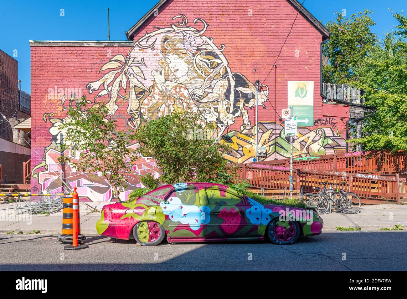 Kensington Market in Toronto, Canada. The Garden Car and painting decorating an old building Stock Photo
