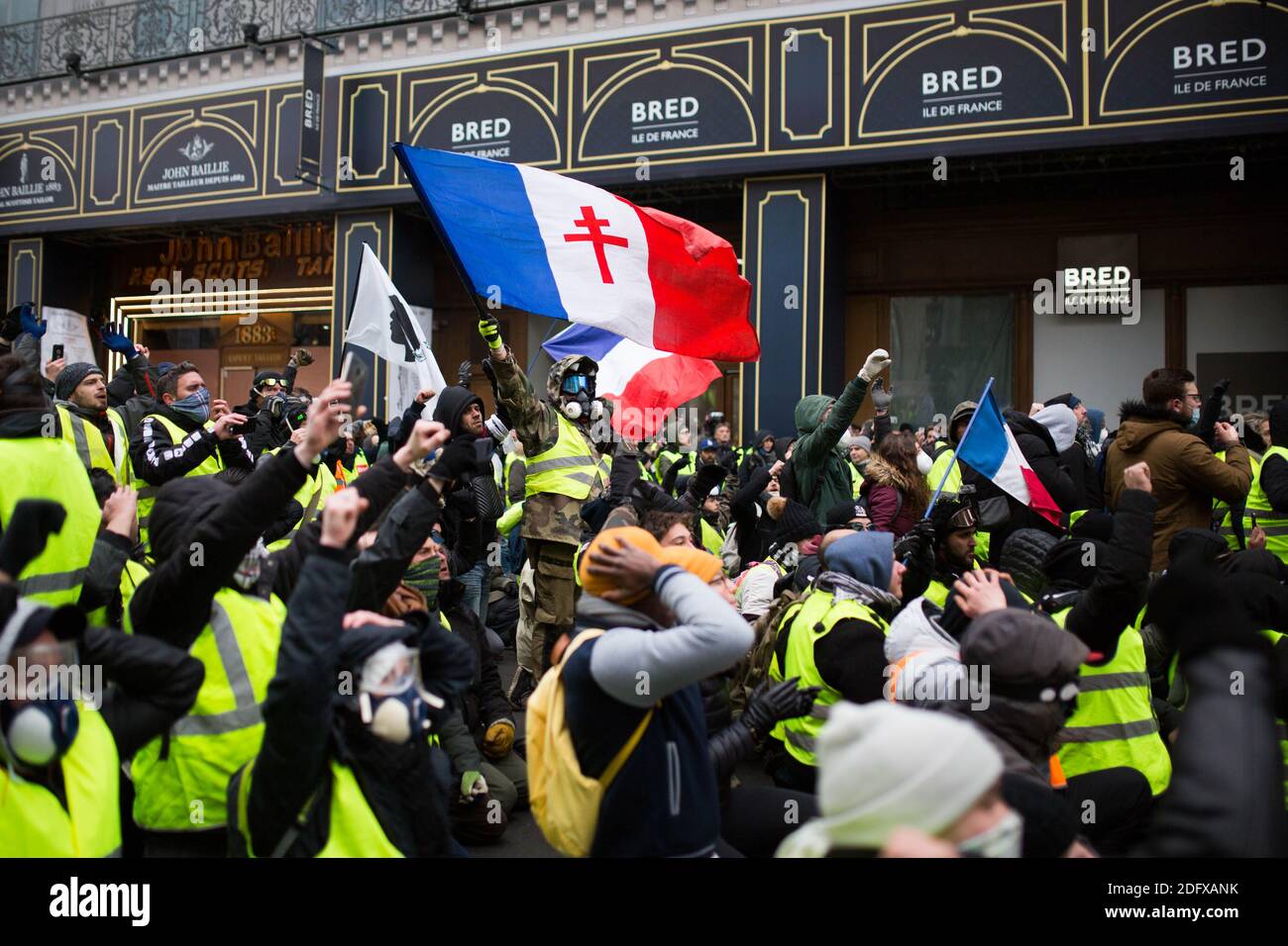 Yellow Vest (Gilets Jaunes) with a Cross of Lorraine (Croix de Lorraine)  flag, used by Rassemblement National party in front of the Opera Garnier,  in Paris on December 15, 2018, during a