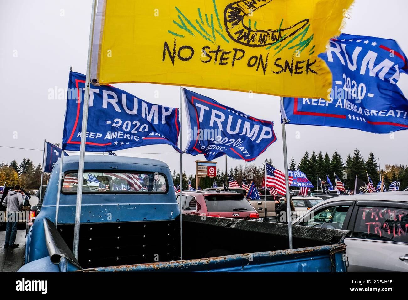 No Step On Snek and Trump flags on back of pickup truck at a Trump