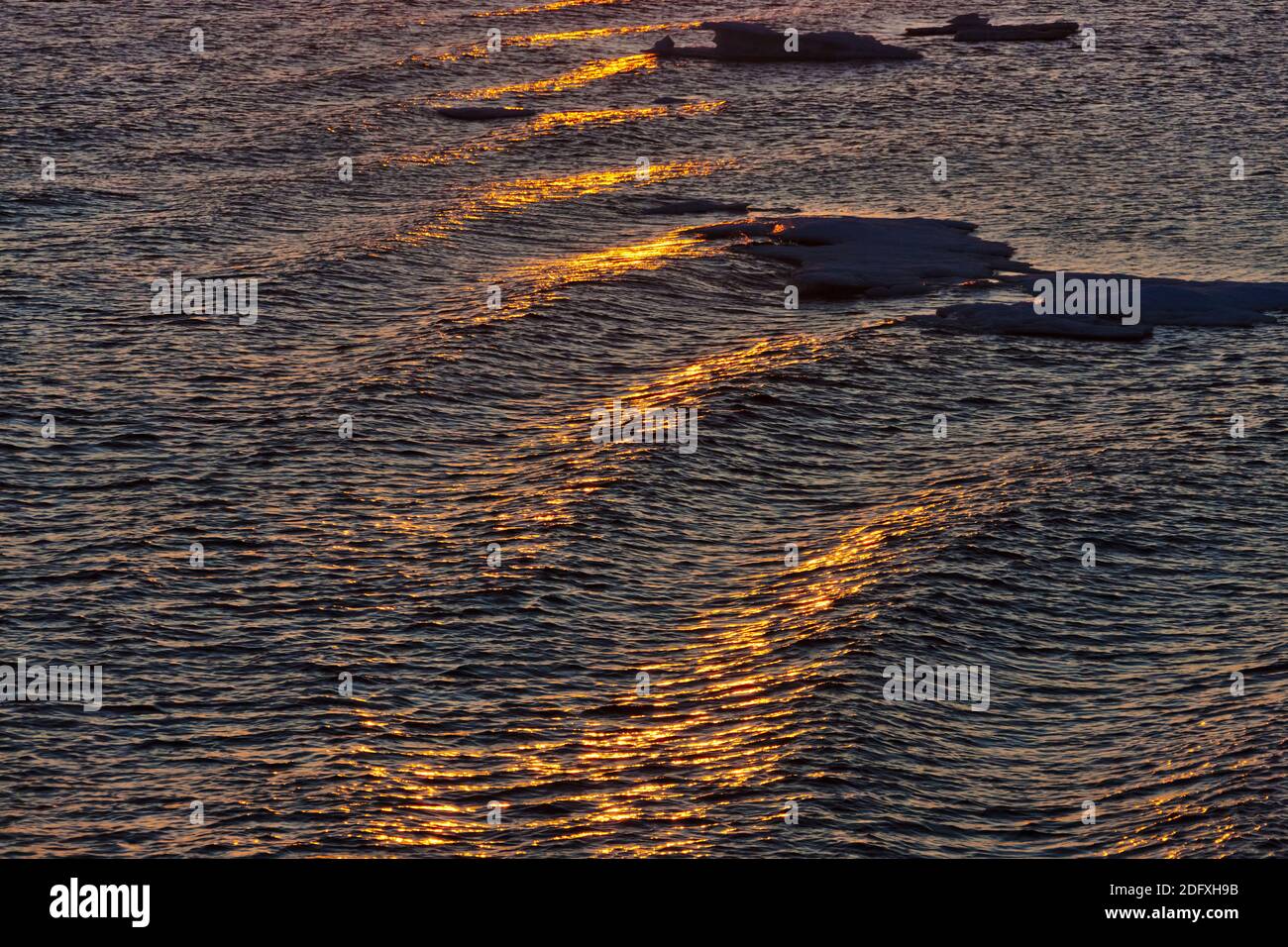 Reflection of sunset in ripples of water, Bering Sea, Russia Far East Stock Photo