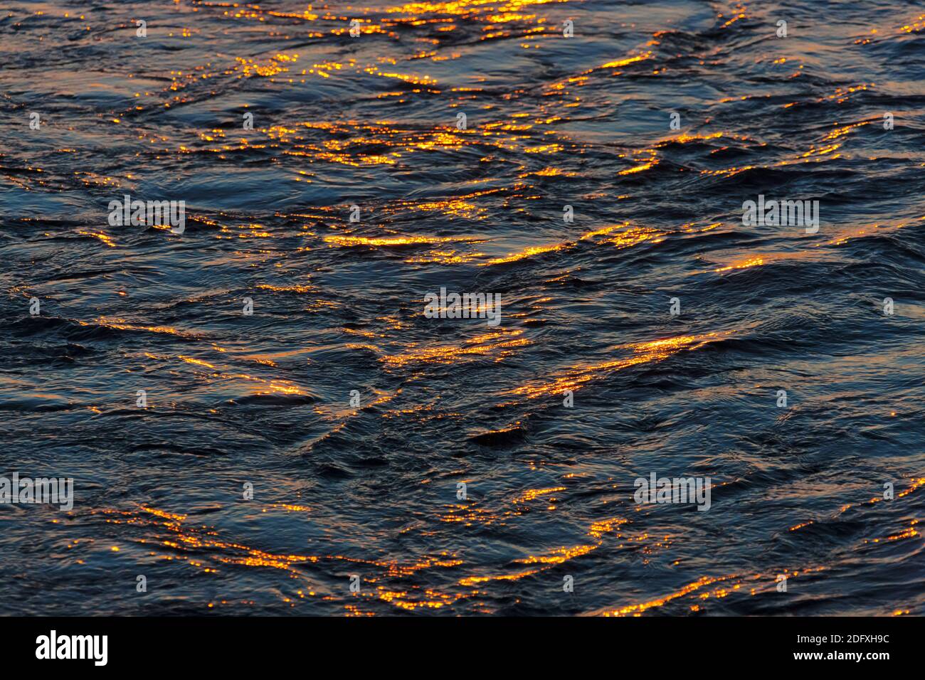Reflection of sunset in ripples of water, Bering Sea, Russia Far East Stock Photo