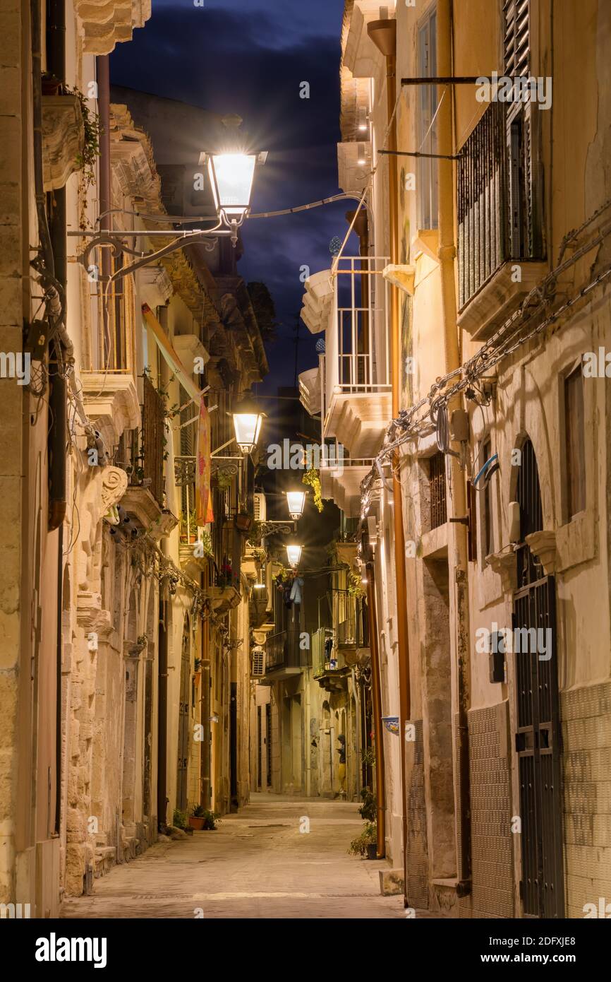 Narrow street in Ortygia, the historical part of Syracuse at night, Sicily Stock Photo