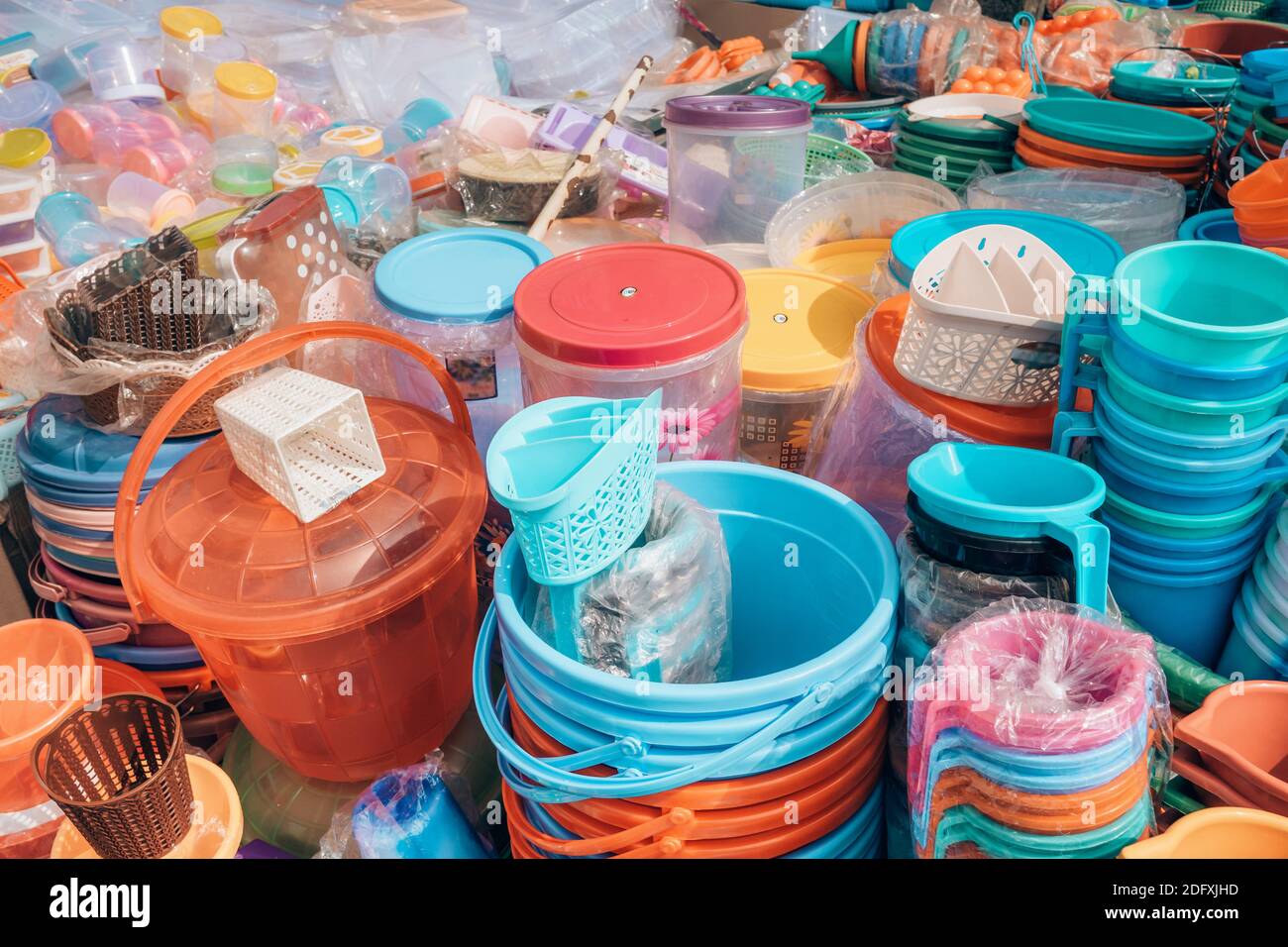 Cheap plastic household items for sale on the market close-up Stock Photo