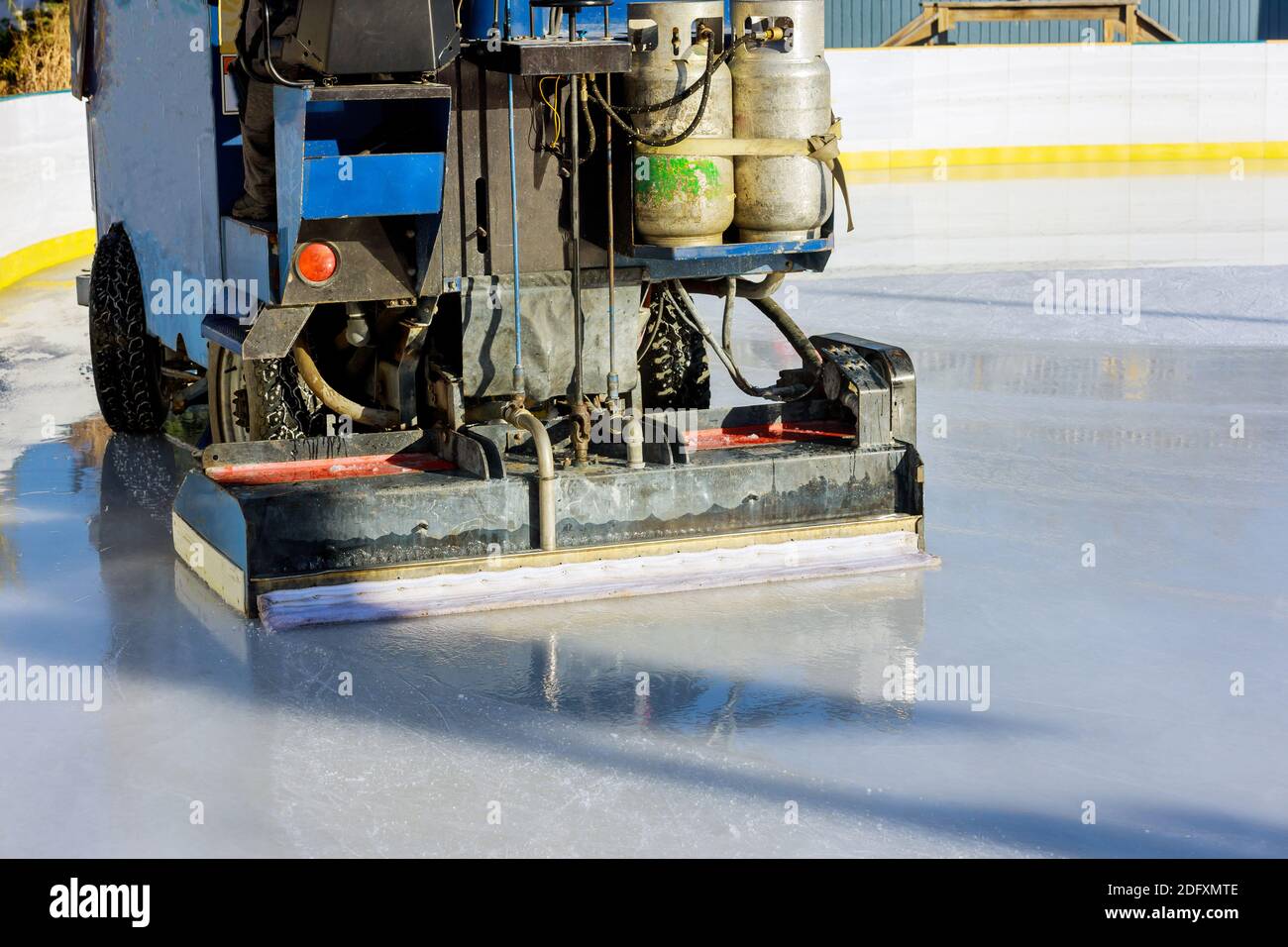Cleaning of ice polishing on the rink by machine Stock Photo Alamy
