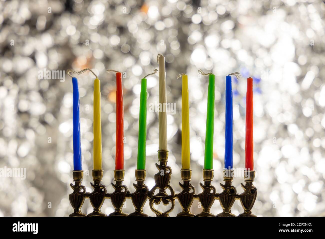 Menorah with candles for Hanukkah celebration over bokeh background Stock Photo