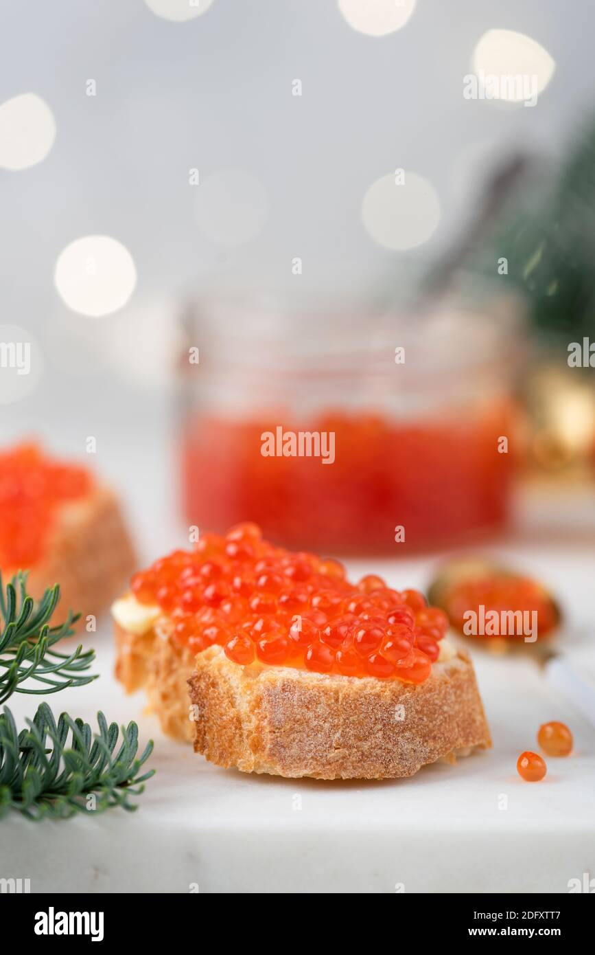 Russian appetizer canape with red caviar on white bread. Christmas, New Year and winter holidays food Stock Photo