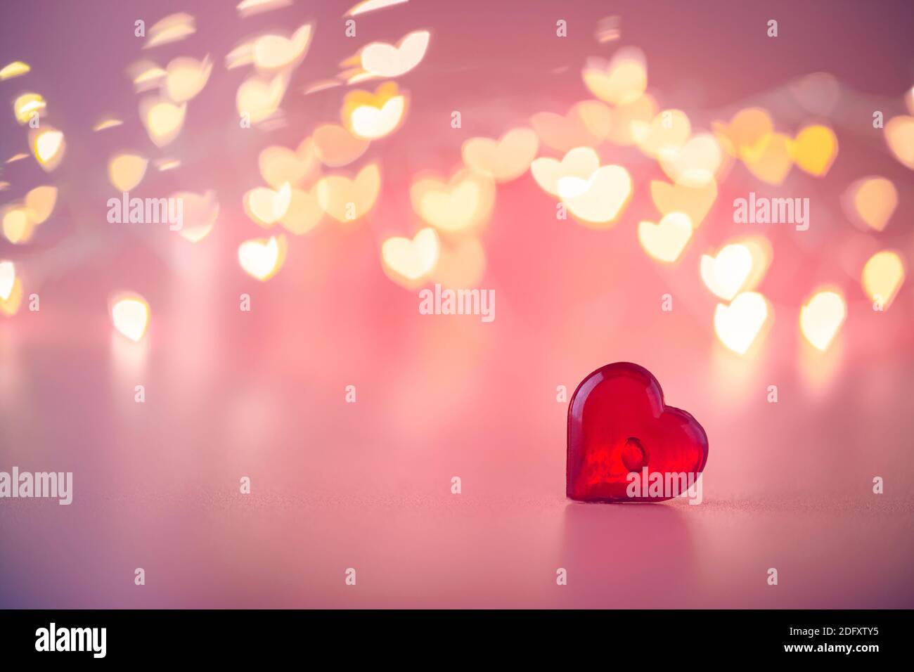 The red Heart shapes on abstract light pink glitter background. Love ...