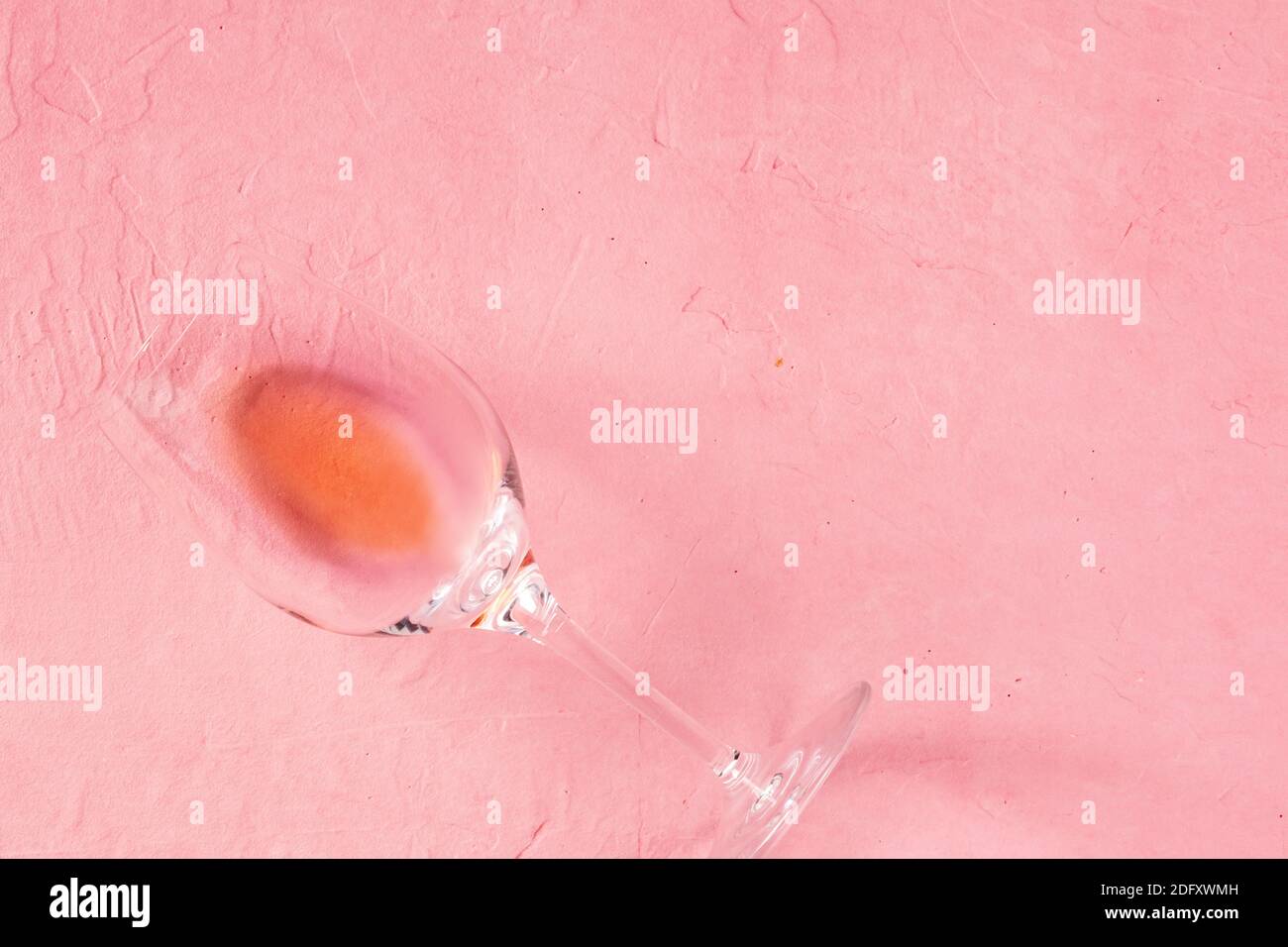Rose wine glass, topdown shot on a pink background, a romantic design