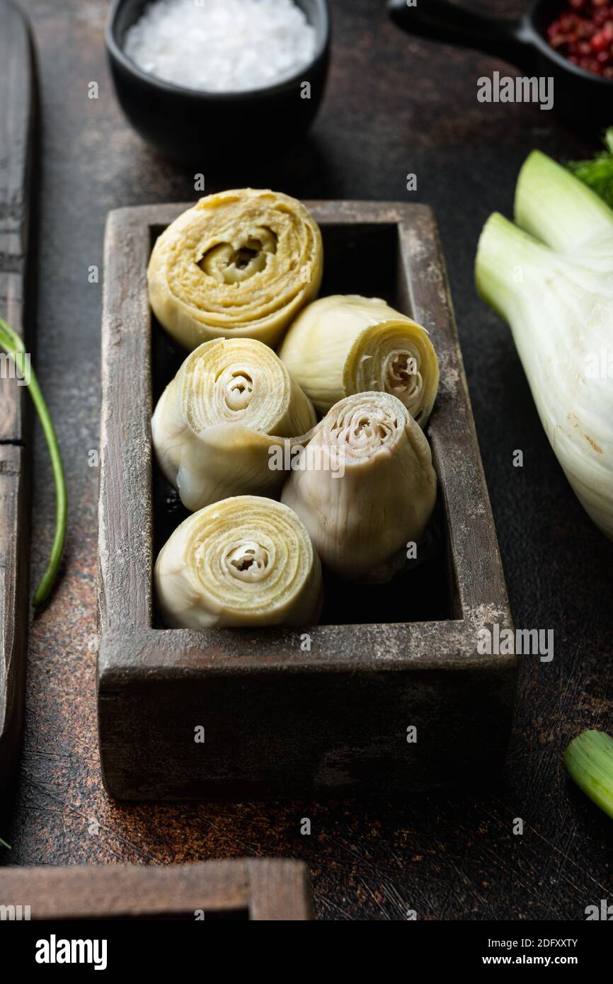 Artichoke hearts marinated with olive oil, on old rustic background