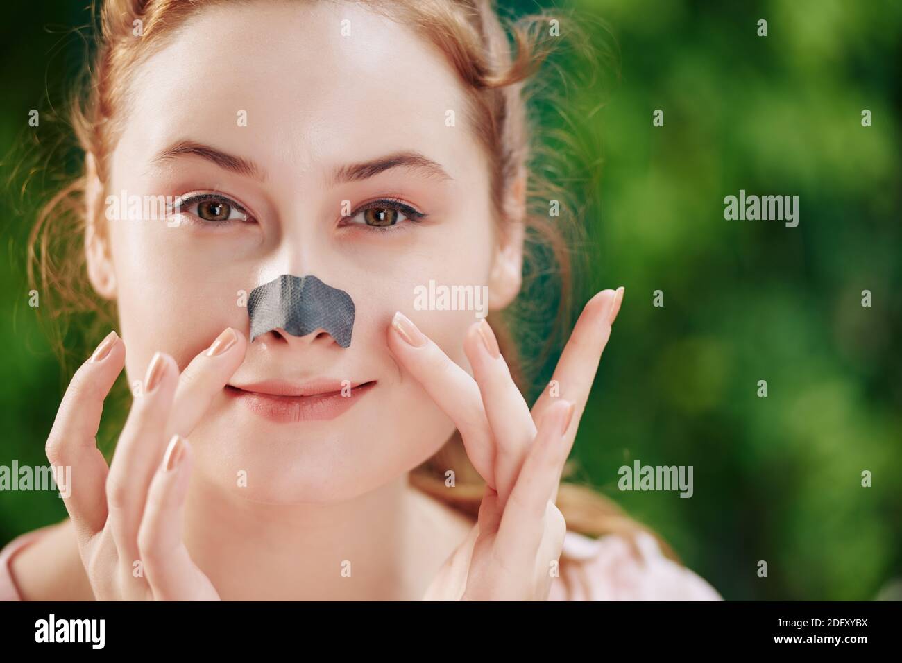 Woman applying nose strip Stock Photo Alamy