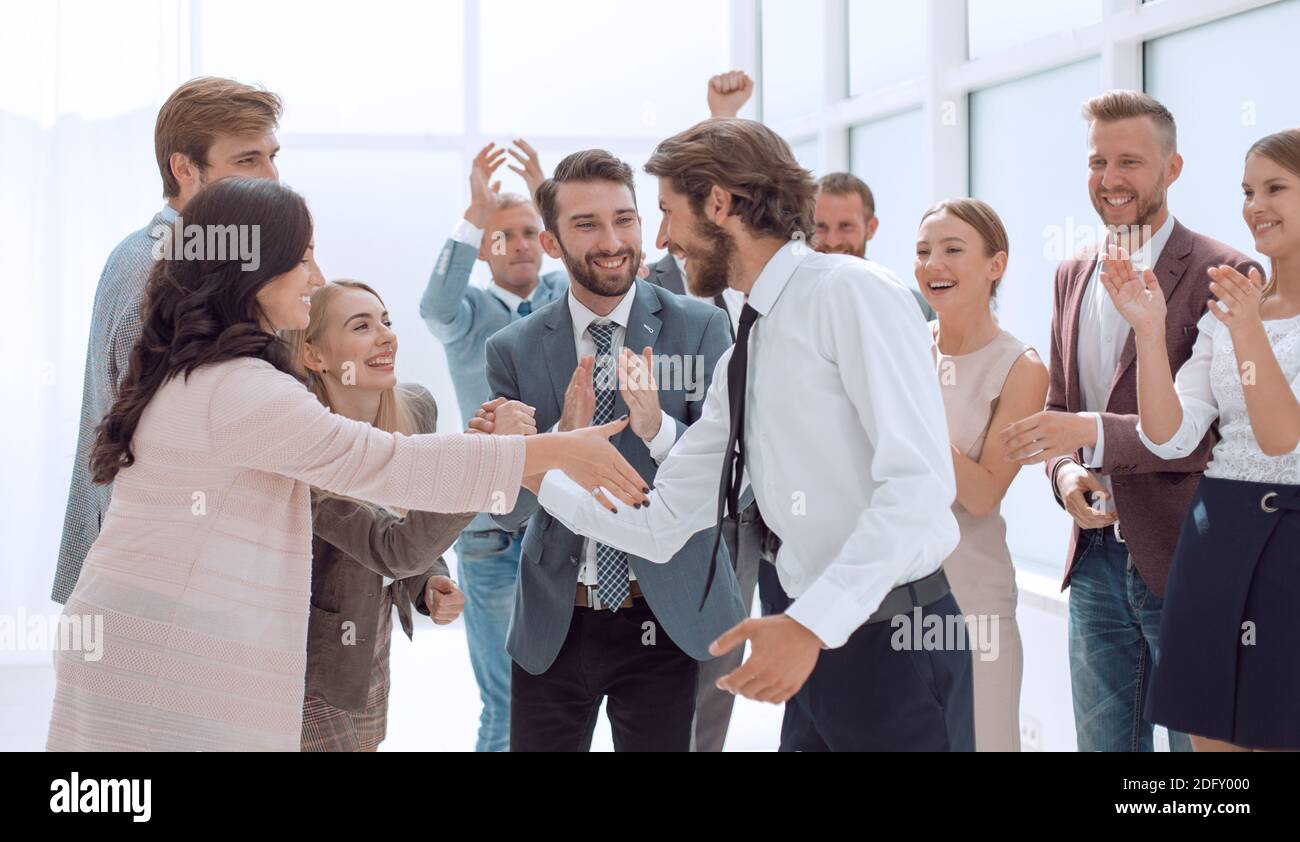 happy young businessman standing in front of his business team Stock ...