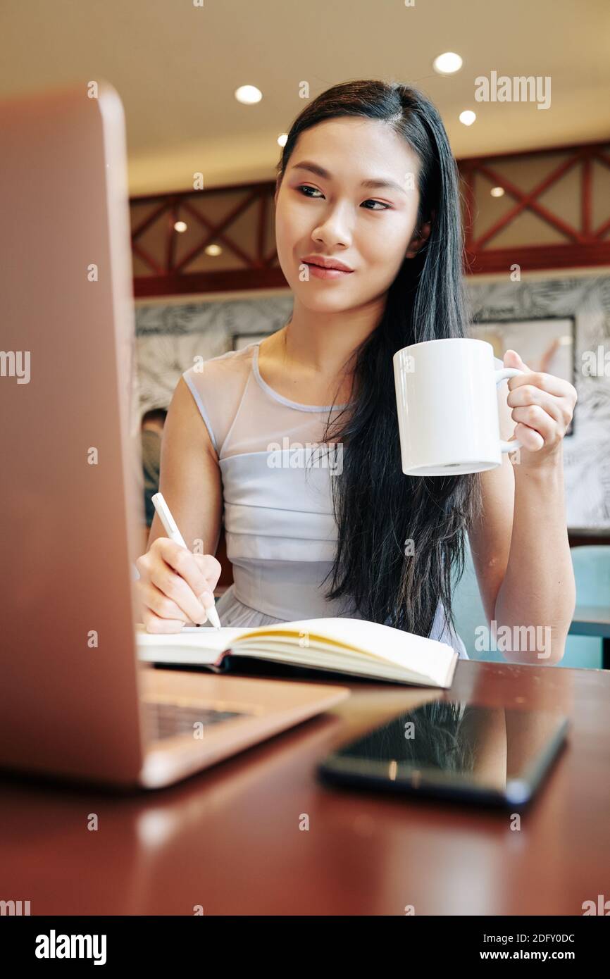 Young woman working on laptop Stock Photo