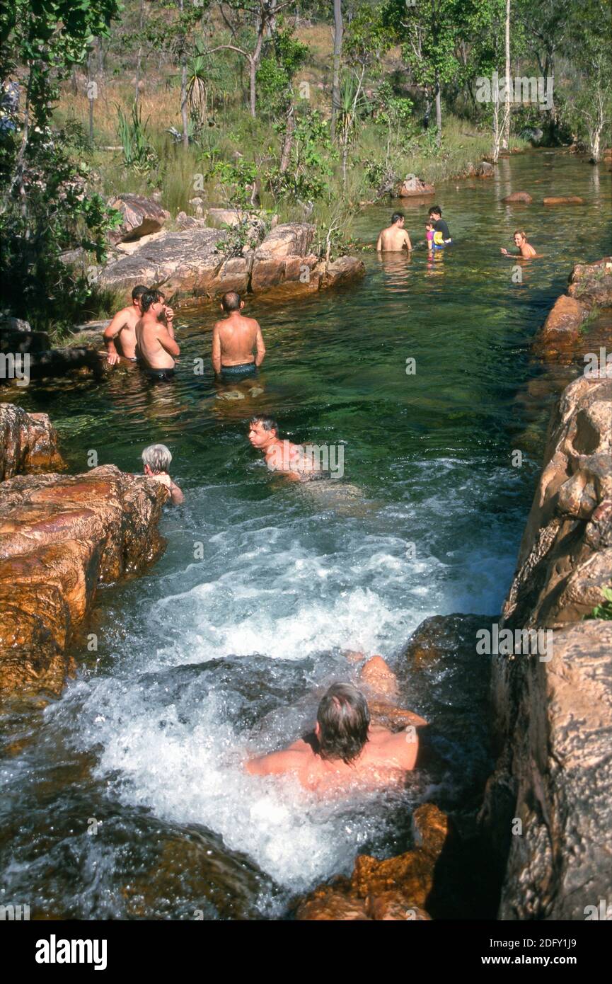 Tolmer Rocks Swimmers enjoy the rock pools at Tolmer Falls, Litchfield NP, Northern ...
