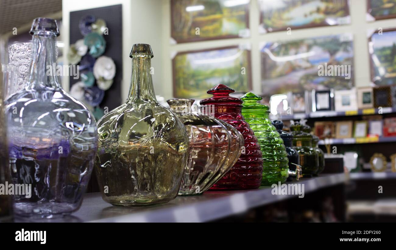Colored glass bottles and vases of various shapes. Beautiful glass