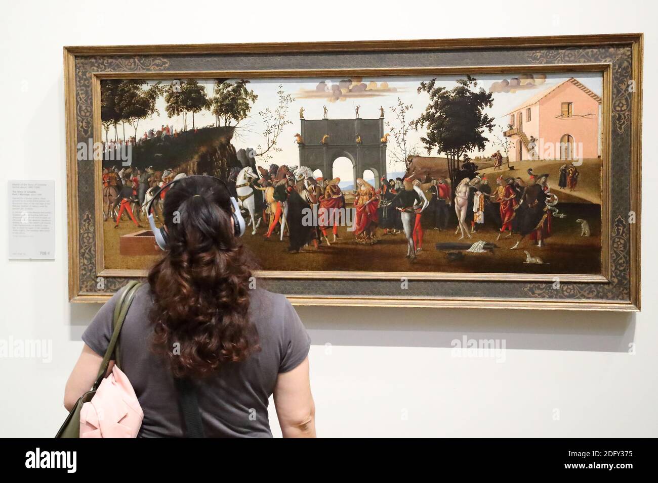A young woman studying a painting 'The Story of Griselda' at the National Gallery, London, UK Stock Photo