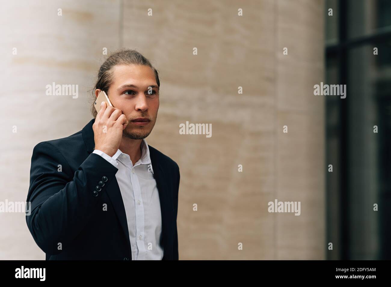 Young businessman talking on mobile phone Stock Photo